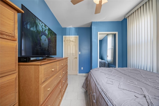 bedroom with light tile patterned floors, baseboards, and ceiling fan