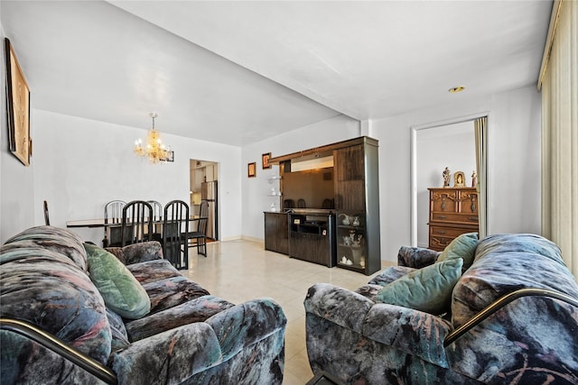 living area featuring light tile patterned floors, a notable chandelier, and baseboards