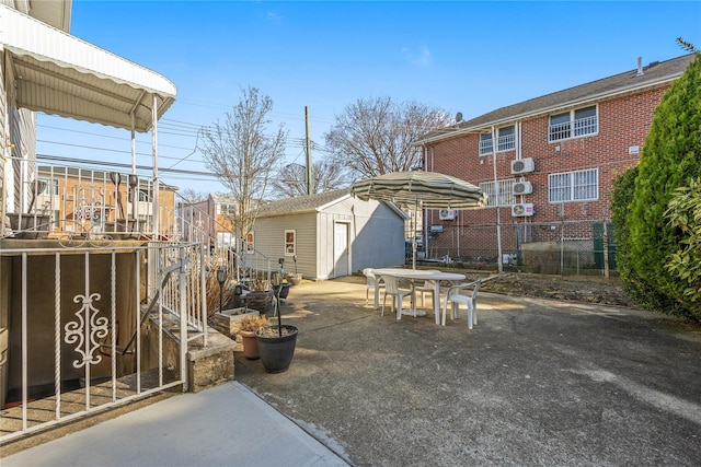 view of patio / terrace with an outbuilding, a shed, and outdoor dining space