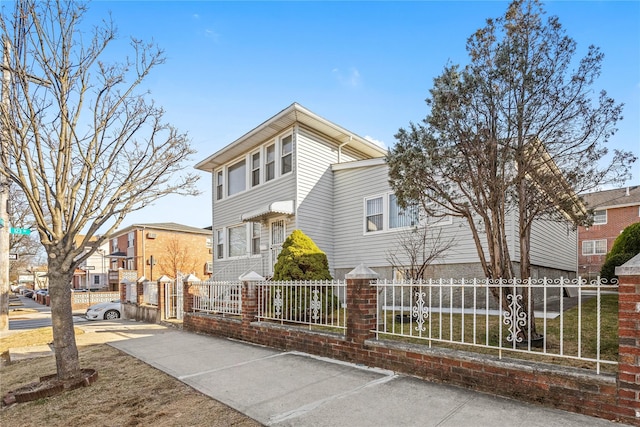 view of front of home with a residential view and a fenced front yard