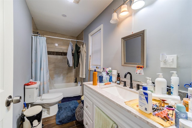 bathroom featuring shower / bathtub combination with curtain, toilet, wood finished floors, and vanity