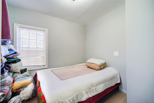 bedroom featuring wood finished floors