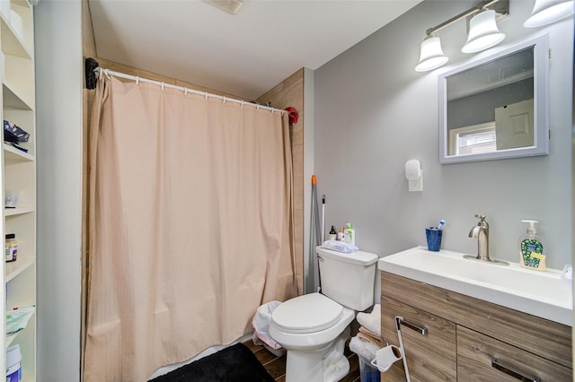 bathroom featuring a shower with curtain, toilet, and vanity