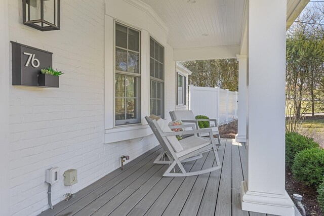 wooden terrace featuring covered porch