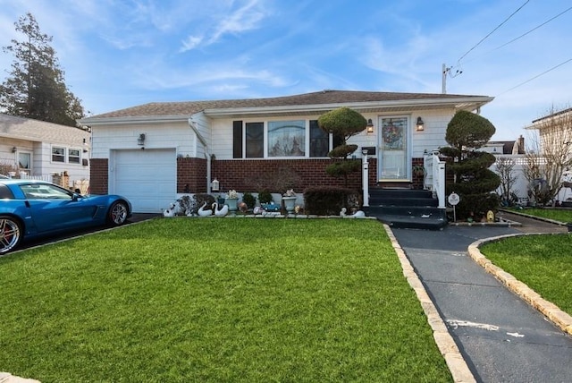 ranch-style home with brick siding, an attached garage, and a front yard