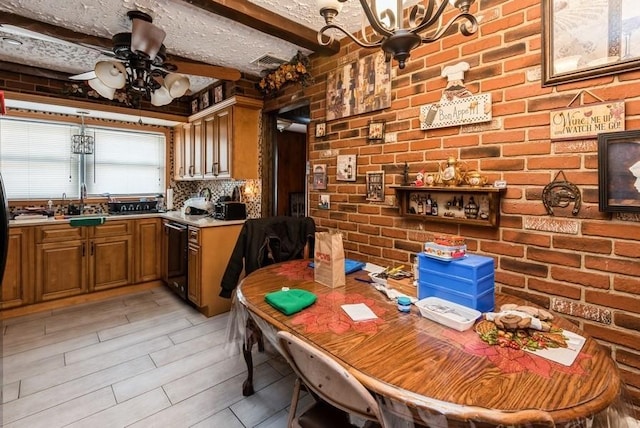 dining space featuring visible vents, brick wall, beam ceiling, ceiling fan with notable chandelier, and a textured ceiling