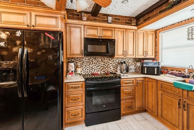 kitchen featuring black appliances, light countertops, backsplash, and a sink