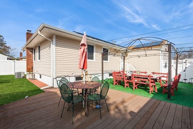 wooden deck with fence private yard, central AC, a gazebo, a lawn, and outdoor dining area