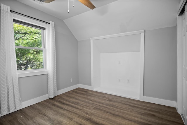 bonus room featuring dark wood-style floors, lofted ceiling, baseboards, and ceiling fan