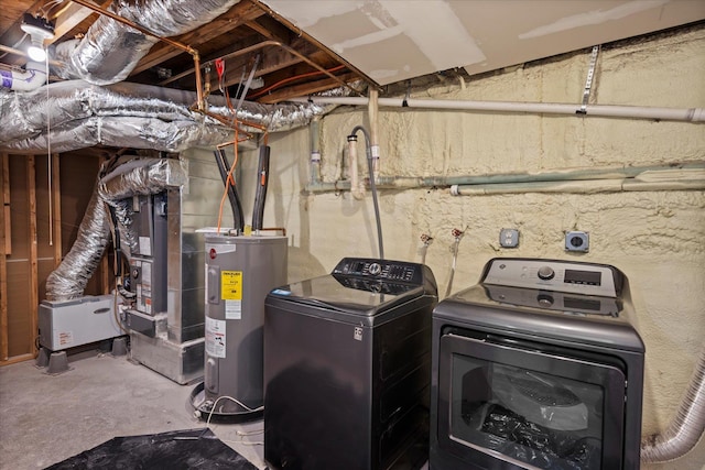 washroom with electric water heater, independent washer and dryer, and laundry area