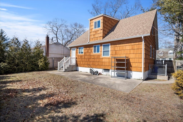 back of house with a patio area, fence, and a shingled roof