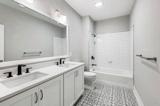 full bath with double vanity, toilet, shower / bath combination, and a sink