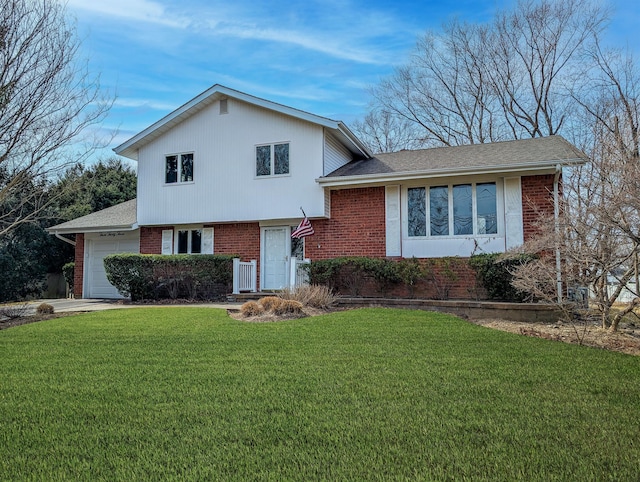 split level home with brick siding, a garage, driveway, and a front yard