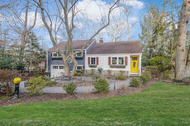 view of front of home featuring a garage, a chimney, a front lawn, and a shingled roof