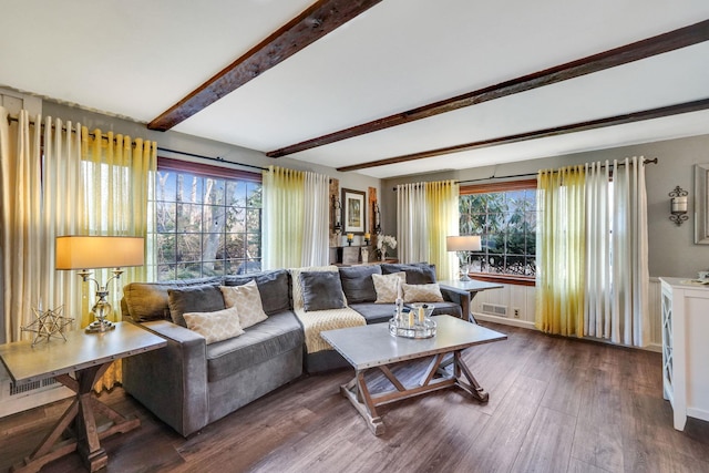 living area featuring beam ceiling, wood finished floors, visible vents, and baseboards