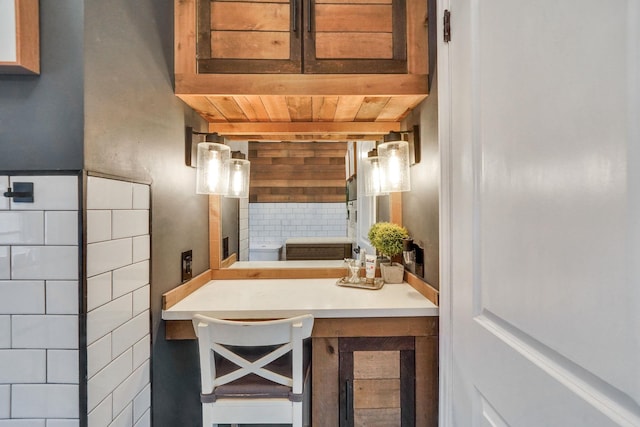 interior space featuring tasteful backsplash and wood ceiling