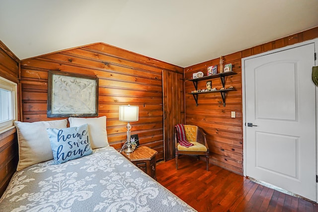 bedroom featuring wood walls, dark wood-style flooring, and vaulted ceiling