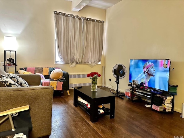 living room with baseboards, wood-type flooring, and radiator