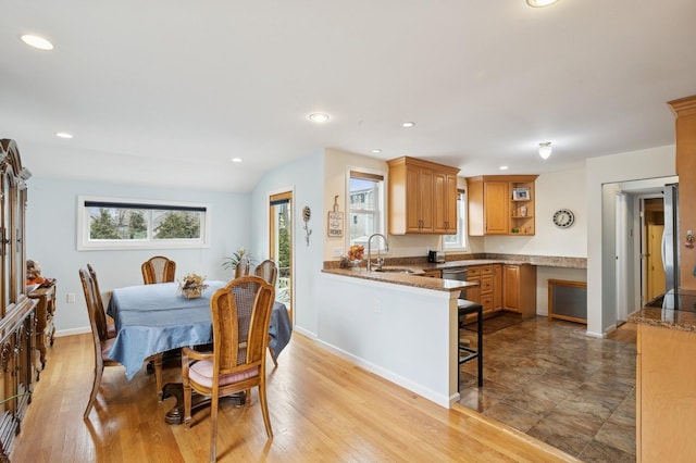 dining area featuring recessed lighting, baseboards, and light wood finished floors