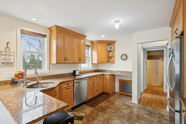 kitchen with a sink, open shelves, stainless steel appliances, a peninsula, and stone counters