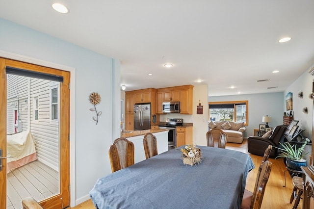 dining space with recessed lighting, light wood-style flooring, baseboards, and visible vents