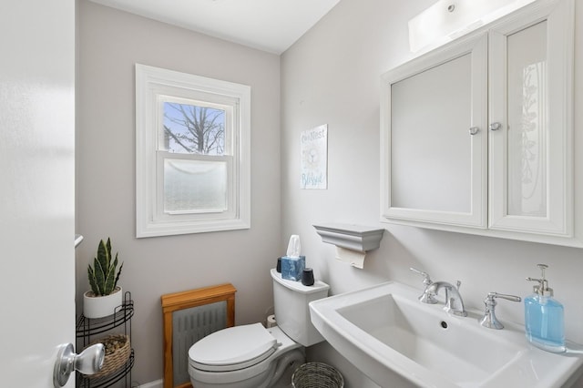 half bathroom featuring a sink and toilet