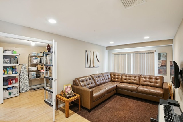 living room featuring recessed lighting, light wood-style floors, and visible vents