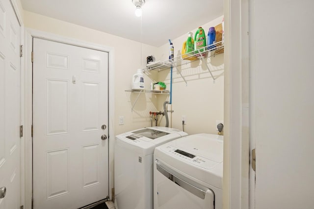 laundry room with separate washer and dryer and laundry area