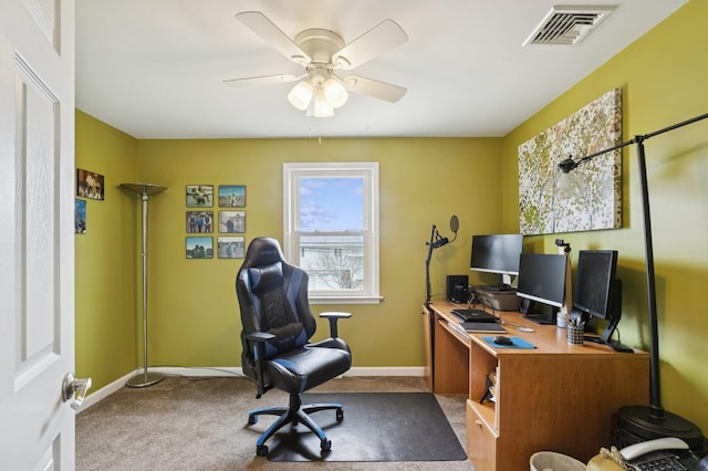 carpeted home office with visible vents, baseboards, and a ceiling fan