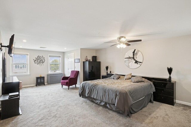 bedroom featuring visible vents, radiator, baseboards, carpet floors, and recessed lighting