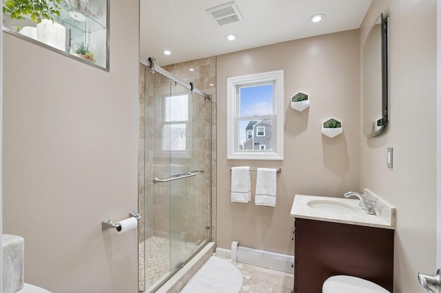 full bathroom featuring visible vents, toilet, a shower stall, baseboards, and vanity