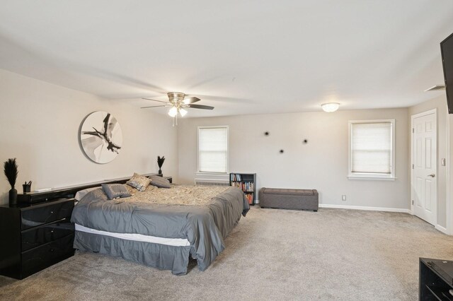 bedroom with ceiling fan, baseboards, and light carpet