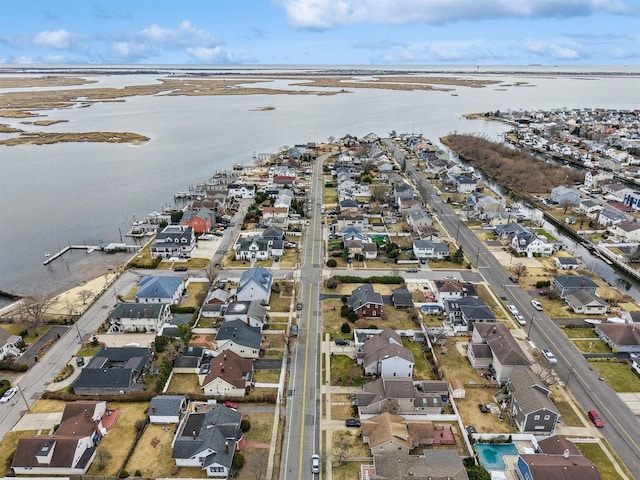 birds eye view of property with a water view and a residential view