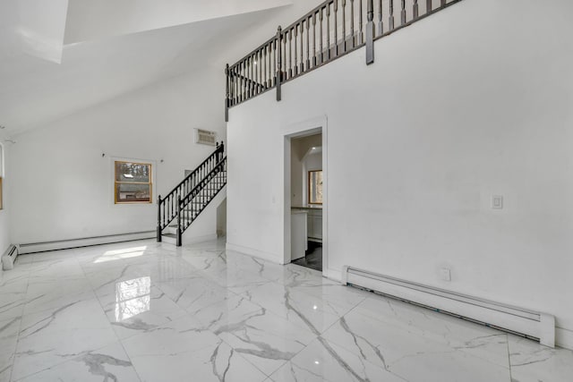 interior space with visible vents, a baseboard heating unit, marble finish floor, and stairway