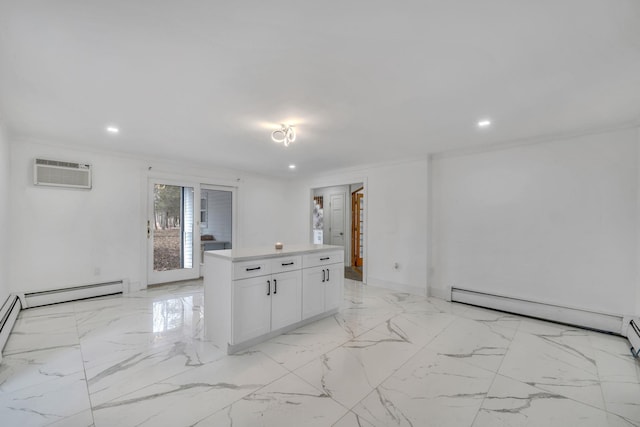 kitchen with marble finish floor, ornamental molding, white cabinets, and a wall mounted AC