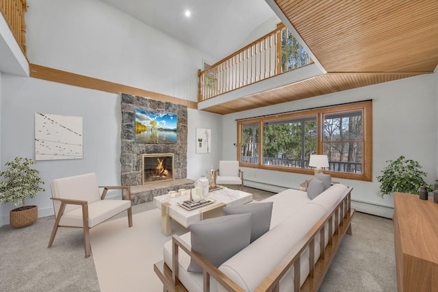 carpeted living area with a fireplace, high vaulted ceiling, and a baseboard heating unit