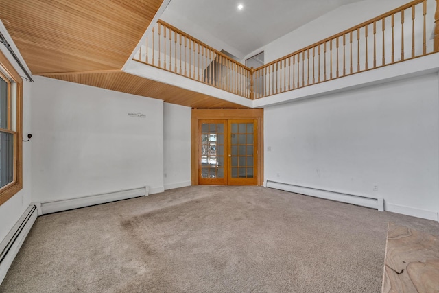 carpeted spare room featuring baseboard heating, french doors, high vaulted ceiling, and a baseboard heating unit