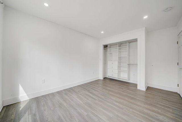 unfurnished bedroom with recessed lighting, baseboards, and wood finished floors