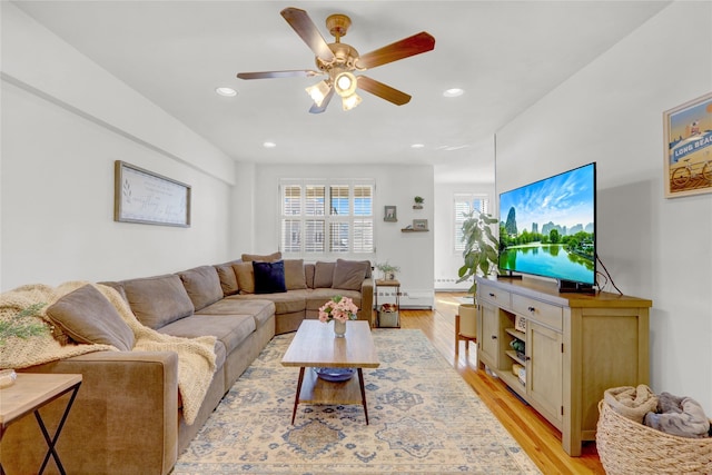 living room with recessed lighting, light wood-type flooring, and a ceiling fan