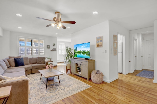 living room featuring recessed lighting, baseboards, light wood finished floors, and ceiling fan