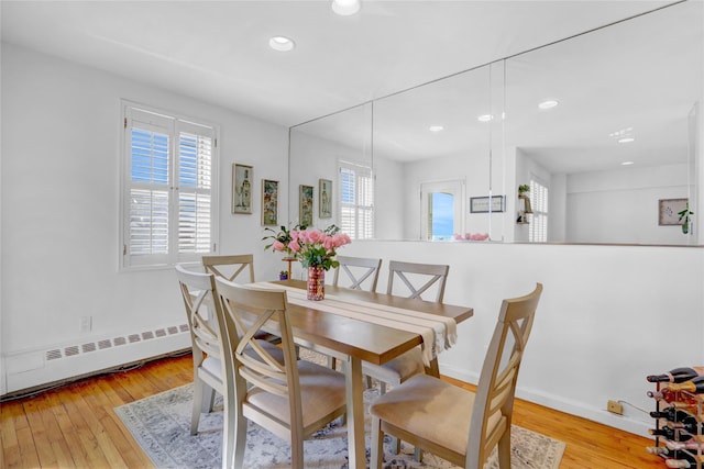 dining space with recessed lighting, baseboards, baseboard heating, and hardwood / wood-style floors