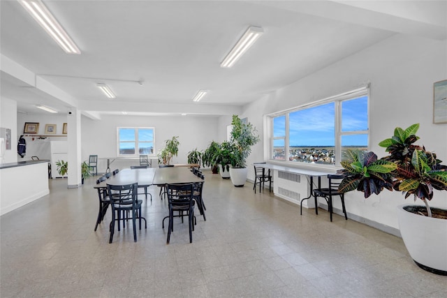 dining room featuring tile patterned floors, radiator heating unit, and baseboards