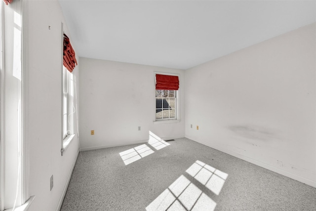 unfurnished room with visible vents and carpet flooring