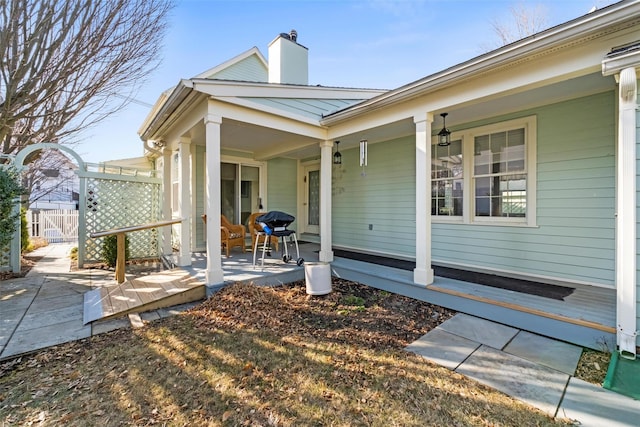 exterior space featuring a patio, fence, and a chimney