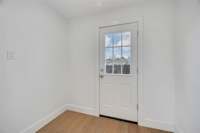 doorway to outside featuring light wood-style floors and baseboards