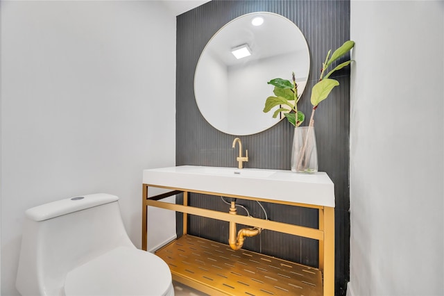 bathroom featuring toilet and a sink