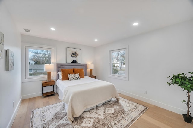 bedroom featuring light wood-style floors and baseboards