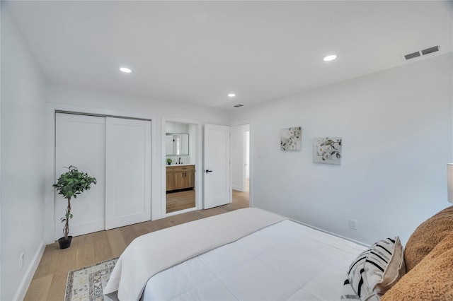 bedroom with visible vents, recessed lighting, a closet, connected bathroom, and light wood finished floors