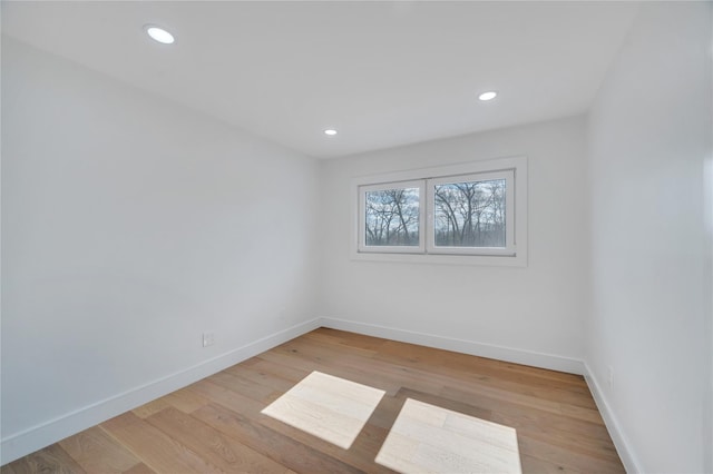 unfurnished room featuring recessed lighting, light wood-style floors, and baseboards