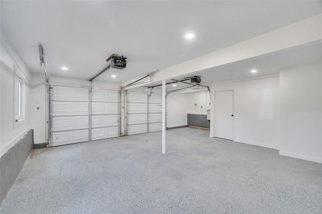 garage with recessed lighting, a garage door opener, and baseboards